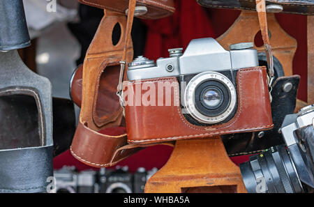 Vintage camera in a brown leather case. Old camera at a flea market. Stock Photo