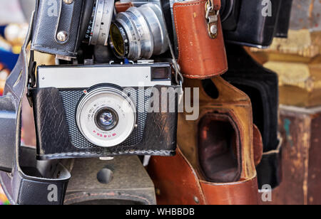 Vintage camera in a black leather case. Old camera at a flea market. Stock Photo