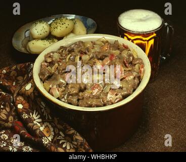 Beef Carbonnade : a beef and beer stew containing onions and peppers , complete with a pint of beer and potatoes Stock Photo