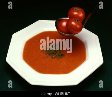 Tomato Soup : combining ingredients such as meat and vegetables in stock or boiling water forming a broth , in this case tomatoes Stock Photo