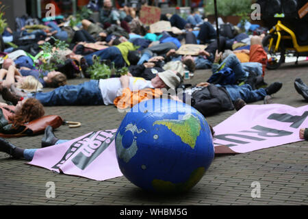 Manchester, UK. 2nd September, 2019. Extinction Rebellion climate protesters take their message around the city centre blocking roads and targeting banks and businesses. Several protesters glued their hands to the premises outside Barclays and HSBC.  The campaigners held several 'die ins' outside Primark, HSBC, Barclays business center and on land earmarked for car parking which the campaigners want turned into green space.  Manchester. UK. Credit: Barbara Cook/Alamy Live News Stock Photo