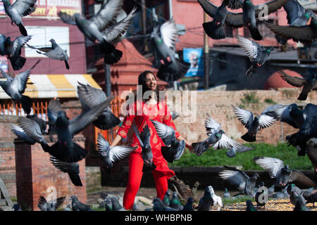 Kathmandu, Nepal. 02nd Sep, 2019. A girl chases a pigeons at the premises of Pashupatinath temple duing a Teej festival in Kathmandu, Nepal on Monday 2 September 2019.During this festival, Hindu women observe a day-long fast and pray for their husbands and for a happy married life. Those who are unmarried pray for a good husband. (Photo by Prabin Ranabhat/Pacific Press) Credit: Pacific Press Agency/Alamy Live News Stock Photo