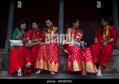 Kathmandu, Nepal. 02nd Sep, 2019. Nepalese Hindu woman take a rest at the Pashupatinath temple during Teej festival celebrations in kathmandu Nepal on 2 September 2019. During this festival, Hindu women observe a day-long fast and pray for their husbands and for a happy married life. Those who are unmarried pray for a good husband. (Photo by Prabin Ranabhat/Pacific Press) Credit: Pacific Press Agency/Alamy Live News Stock Photo