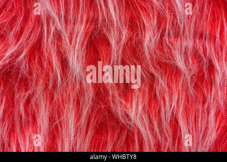 Texture of red artificial fur. Fur background for design and decoration. Stock Photo