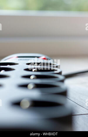 A close up portrait of an electric plug system with a switch to turn off the power of the sockets. Stock Photo