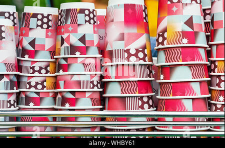 Bright disposable cups on the counter of an outdoor cafe. Paper cups for various drinks. Stock Photo
