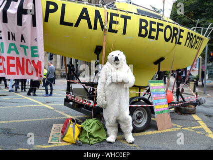 A person in a polar bear suit on Deansgate as Northern Rebellion protesters, part of the global movement Extinction Rebellion, marched through Manchester, uk, and held a series of die-ins to urge for action on climate change on September 2nd, 2019. Protest sites included Barclays Bank, a Primark store and HSBC Bank. This was the fourth day of a protest which blocked Deansgate, a main road in central Manchester. Stock Photo