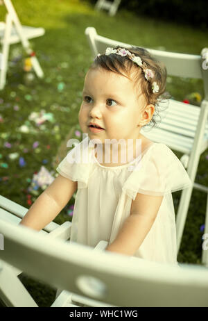 Cute baby girl in white dress on a family wedding Stock Photo