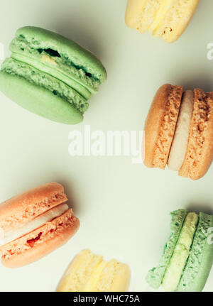 Freshly baked painted macarons on a white background, isolate. French pastries Stock Photo