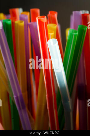 Bunch of colored plastic straws isolated on white background close up ...