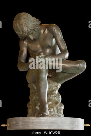 Boy with Thorn, bronze statue in Capitoline Museums, Rome, Italy. 1st century BC. Isolated on black Stock Photo