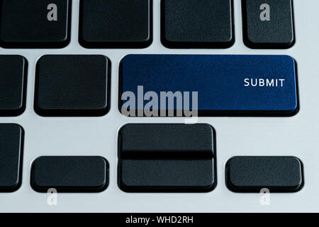 Submit on laptop keybaord. Theme of social media and online communication Stock Photo