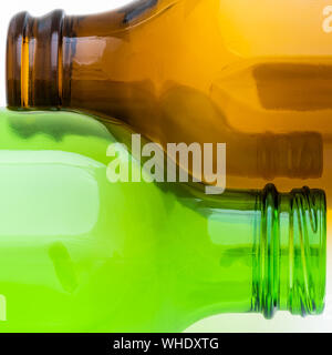 Abstract beautiful curves of an empty brown and green beer bottle lying side by side on a white background Stock Photo