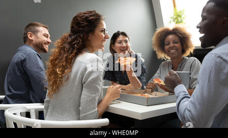 Cheerful multiracial business team people having fun eating pizza together Stock Photo