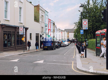 People Walking In The Street At Portobello Market With Colourful