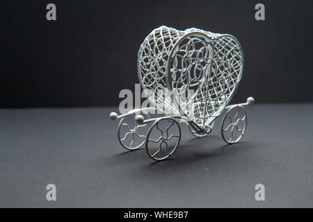 The carriage, the wagon. On a black background white metal beautiful. The best. handwork Stock Photo
