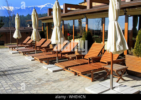 Resort terrace with swimming pool and sunny lounges Stock Photo