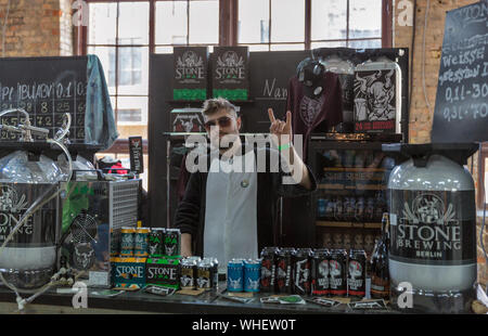 KYIV, UKRAINE - MAY 18, 2019: Bartender works at Stone Brewing Berlin brewery booth during Kyiv Beer Festival vol. 4 in Art Zavod Platforma. More than Stock Photo
