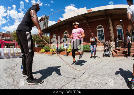 A woman jumps rope double dutch style at the Pretty Girls Sweat Fest, on September 15, 2018 in Atlanta, GA. Stock Photo