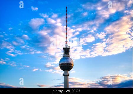 A view of the television tower (Fernsehturm) over the city of Berlin, Germany at sunset. Stock Photo