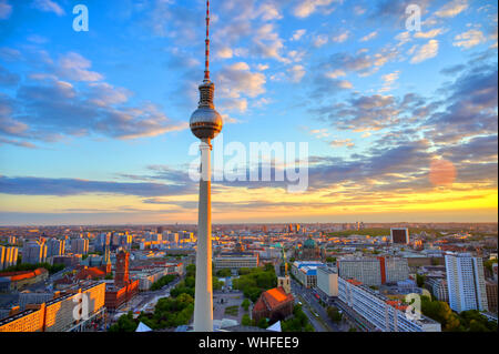 A view of the television tower (Fernsehturm) over the city of Berlin, Germany at sunset. Stock Photo