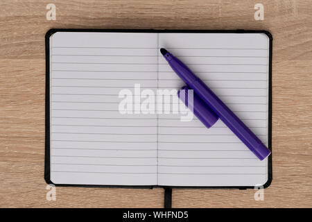 Top view of open notebook and blue marker Stock Photo