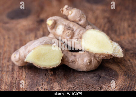 fresh ginger on dark wood Stock Photo
