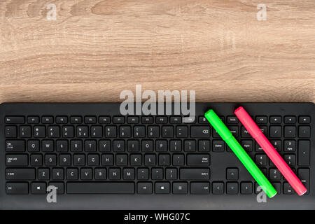 Close up view of colored pens on black keyboard Stock Photo