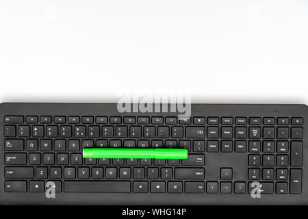 Green marker and keyboard on white background Stock Photo