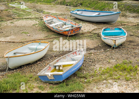 Five small rowing boats laying on the beach Stock Photo