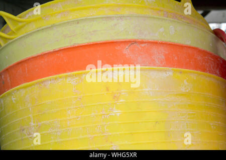 Colourful plastic builder's buckets in a heap shot as a background Stock Photo