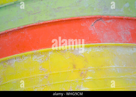 Colourful plastic builder's buckets in a heap shot as a background Stock Photo
