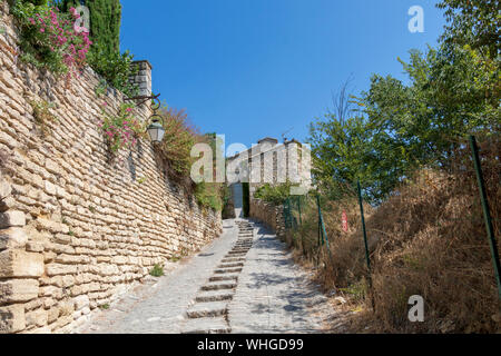 Gordes beautiful old village with pastel buildings on the hill surrounded by mountains, popular tourist destination in Provence, France Stock Photo