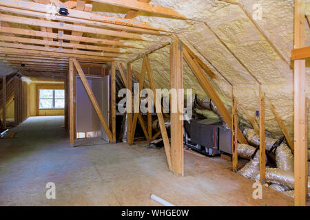 Foam plastic insulation installed in the sloping attic of a new frame house. Stock Photo