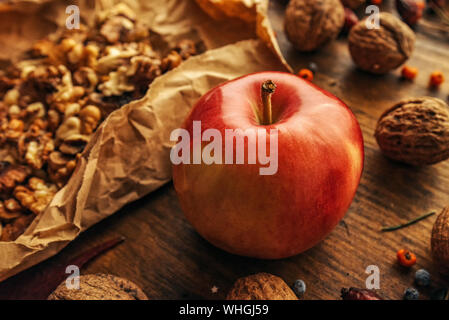 Autumn fruit, apple and walnuts, rustic retro toned image Stock Photo