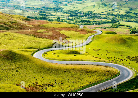 Empty winding road through hills Stock Photo