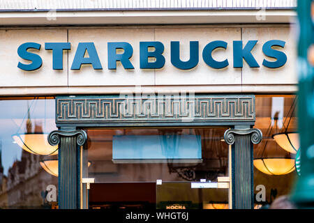 Prague, Czech Republic - 12th April 2019: A Starbucks sign in blue on the front of one of their famous coffee shops Stock Photo