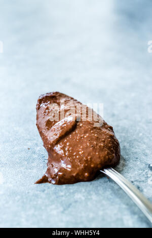 Homemade Organic Raw Nut Chocolate Cream in Spoon. Ready to Eat. Stock Photo