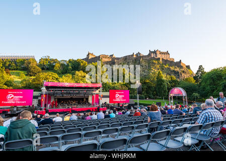 Audience waiting for Virgin Money fireworks concert, Edinburgh International Festival 2019, with Edinburgh Castle in evening sun, Scotland, UK Stock Photo