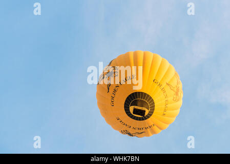 BAGAN, MYANMAR - 06 DECEMBER, 2018: Horizontal picture of huge yellow hot air balloon in the sky of Bagan, Myanmar Stock Photo