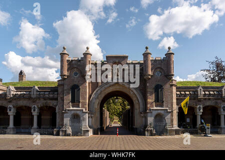 Medieval access portal of the fortification works of the Naarden Vesting in The Netherlands on a sunny day with blue sky and clouds Stock Photo
