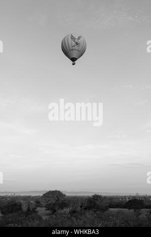 BAGAN, MYANMAR - 06 DECEMBER, 2018: Black and white picture of hot air balloon flying over the old temples in Bagan, Myanmar Stock Photo