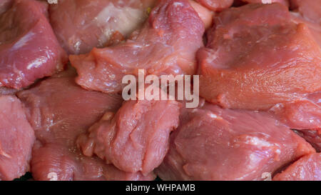 Raw meat. Meat dishes are prepared in the restaurant by the chef. Sliced pork. Minced fillet. Preparation for barbecue or kebab. Cut meat. Pieces on a Stock Photo