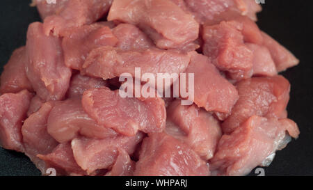 Raw meat. Meat dishes are prepared in the restaurant by the chef. Sliced pork. Minced fillet. Preparation for barbecue or kebab. Cut meat. Pieces on a Stock Photo