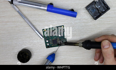 Workshop on repair of household appliances, electronics and processors. soldering Board soldering iron, re-soldering chips, replacing transistors, thy Stock Photo