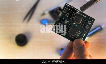 Workshop on repair of household appliances, electronics and processors. soldering Board soldering iron, re-soldering chips, replacing transistors, thy Stock Photo