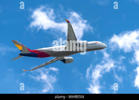 Passenger airplane Airbus A350 of Asiana Airlines flying through clouds sky take off from Tan Son Nhat International Airport, Ho Chi Minh City, Vietna Stock Photo