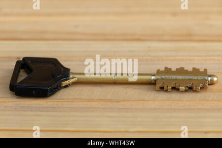 A key on a wooden background close up. Stock Photo