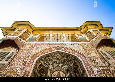 Stunning view of the decorated facade of the Amer Fort in Jaipur during a beautiful sunset. Amer Fort is a fort located in Amer, Rajasthan, India. Stock Photo