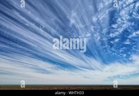 Long streaky white clouds with blue sky on a sunny day Stock Photo